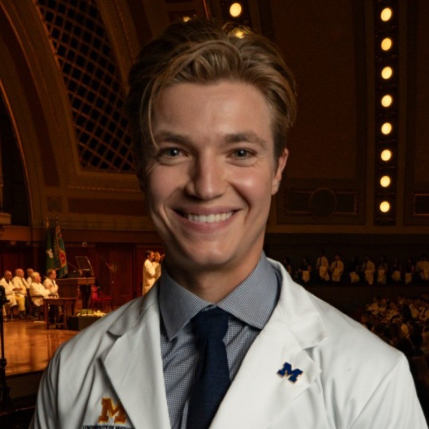 Jack Hennessey wearing his University of Michigan Medical School white coat